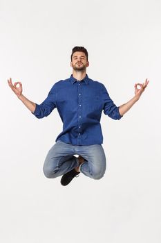 Portrait peaceful businessman meditating on white background.