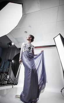 in full growth. beautiful woman model posing in a chic evening dress. beauty and fashion