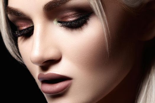 Closeup portrait with of beautiful woman face. Fashion makeup, clean shiny skin. Makeup and cosmetic. Beauty style on model face. Blond hair style