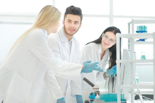 group of young scientist discussing something in their lab . photo with copy space