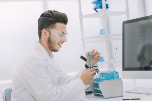 modern scientist examines test tube with liquid. science and health