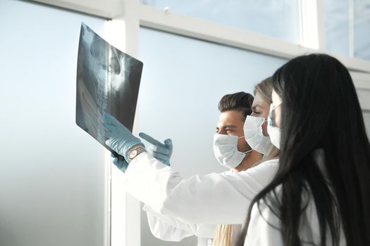 close up. a group of doctors discussing the x-ray .photo with copy space