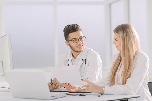 doctors colleagues talking sitting at a table in the office.photo with copy space