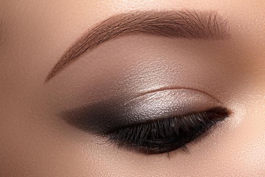 Beautiful Macro Eyes with Smoky Cat Eye Makeup. Cosmetics and Make-up. Closeup of Fashion Visage with Liner, Eyeshadows.