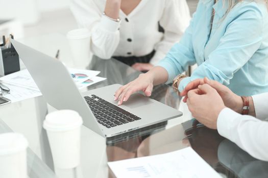 business team uses a laptop to analyze financial data . business strategy