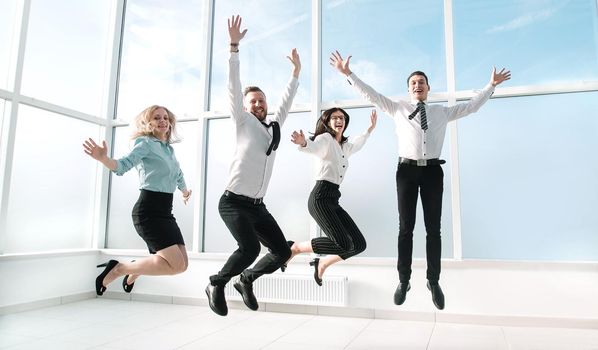 happy business team having fun in an empty new office. the concept of a startup