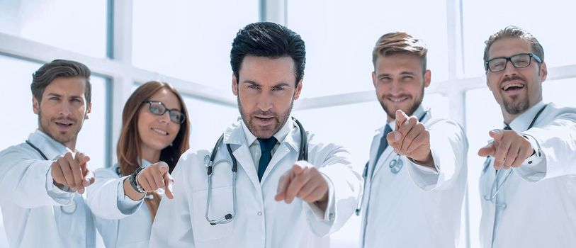 group of confident doctors pointing their finger at you.the concept of health