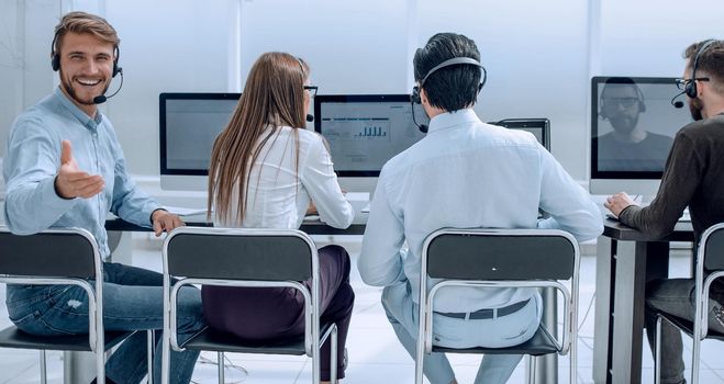 rear view.the operators of the business center sitting at a Desk . photo with copy space