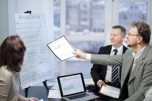 business team and investors discussing the company's profit in a modern office