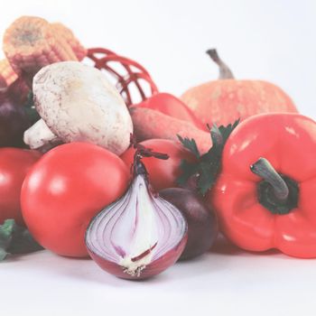 closeup of vegetables-tomatoes capsicum onions lettuce on a white background. the photo has a empty space for your text