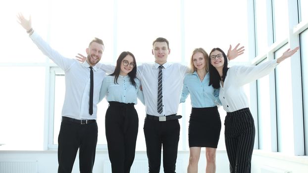 group of young professionals standing near the office window. business and education