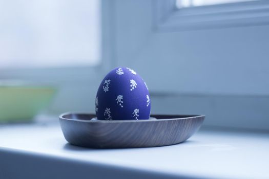 festive Easter egg in a stylish holder . photo with copy space