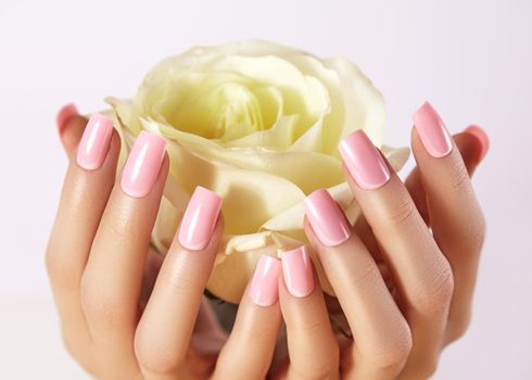 Manicured nails with pink nail polish. Manicure with nailpolish. Fashion art manicure with shiny gel lacquer. Nails salon