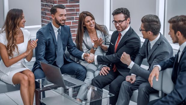 business team applauding business partners at an informal meeting.the concept of cooperation