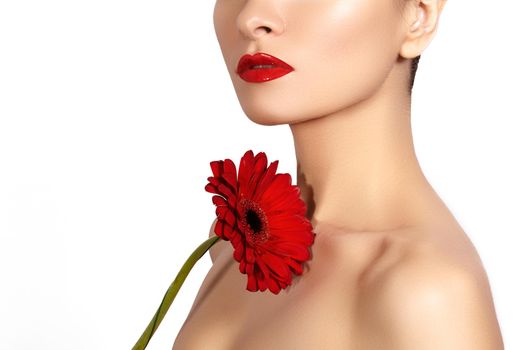 Close-up beauty photo sexy woman with red lips, lipstick and beautiful red flower. Spa portrait female face with clean skin