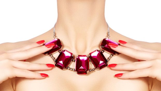 Fashion woman with elegant luxury jewelry. Beautiful girl with bright necklace on white background. Fashionable jewellery and accessories