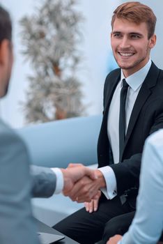 handshake business partners in the lobby of the office. photo with copy space