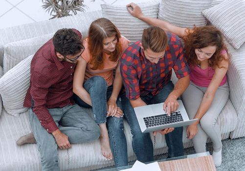 view from the top. the group of friends with a laptop,discussing the video