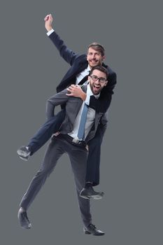 happy businessman carrying his colleague on the piggyback . isolated on white background