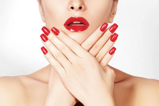 Red lips and bright manicured nails. Sexy open mouth. Beautiful manicure and makeup. Celebrate make up and clean skin. Kiss