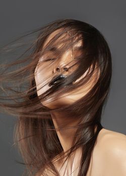 Fashion Model with Long Blowing Hair. Glamour Asian Beautiful Woman with Beautiful Brown Hair. Fashion Style, Clean Skin.