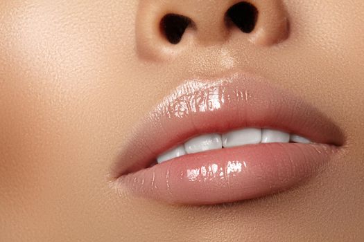 Moisturizing lip balm, lipstick. Close-up of a beautiful sexy wet lips. Nice full lips with gloss lip makeup. Filler Injections, Plastic Surgery, Collagen and Treatments