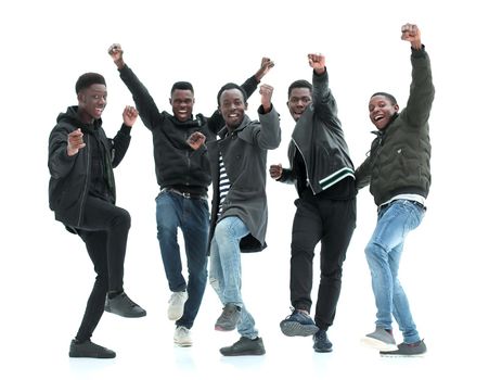 in full growth. group of happy guys standing with hands up . isolated on white background