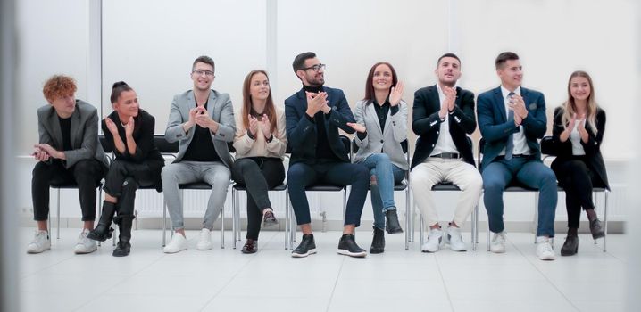 group of diverse business people applauding sitting in a row. photo with copy space