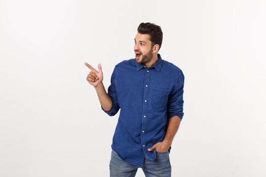 Man pointing showing copy space isolated on white background. Casual handsome Caucasian young man