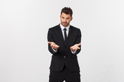 Portrait of confident mature businessman in formals standing isolated over white background.