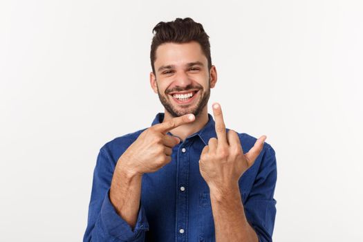 Handsome young man showing middle finger gesturing Screw you with white background