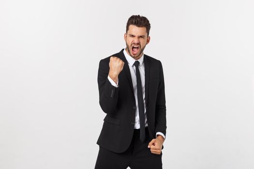 Portrait of a energetic young business man enjoying success, screaming against white - Isolated