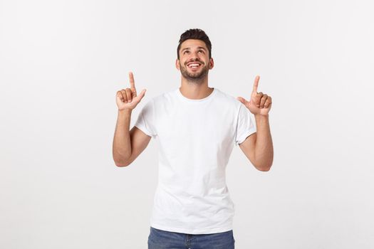 Man pointing showing copy space isolated on white background. Casual handsome Caucasian young man