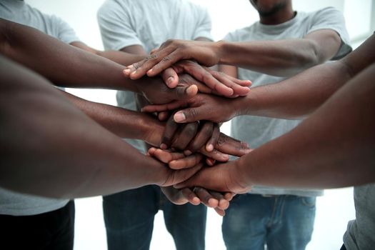 close up. a multi-ethnic group of friends showing their unity . isolated on white