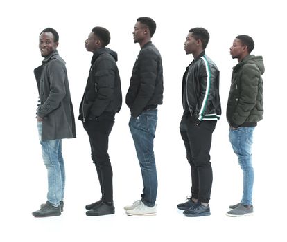 in full growth. a group of diverse guys standing in turns . isolated on white background