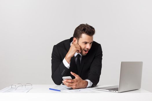 young man shocked with something he see on his laptop computer