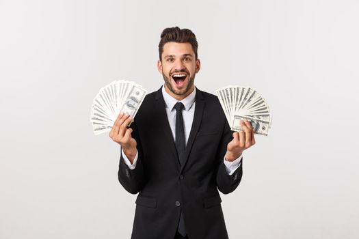 Portrait of a satisfied young businessman holding bunch of money banknotes isolated over white background