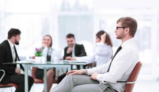 confident businessman on background of office.photo with copy space.