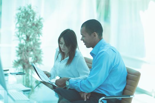 business colleagues discussing documents sitting at a Desk in the office.photo with copy space