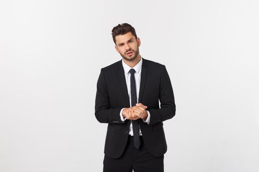 Well dressed man in the studio emphasize thoughtful thinking, think carefully and try to choose to hold hands and stand against the white background