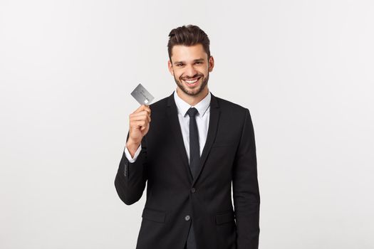 Surprised, speechless and impressed handsome caucasian businessman in classic suit showing credit card, say wow, standing white background astonished.