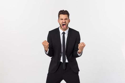 Young businessman celebrating his success over gray background