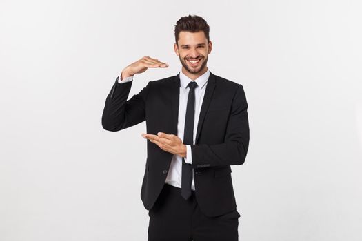 A man shows with his hands a large size on an isolated background.