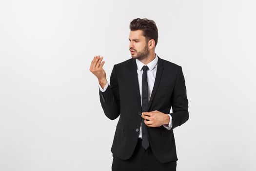 Portrait of confident mature businessman in formals standing isolated over white background.