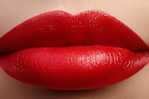 Close-up of female lips with bright makeup. Macro of woman's face. Fashion lip make-up with red gloss.Red lipgloss makeup on full female lips