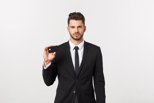 Surprised, speechless and impressed handsome caucasian businessman in classic suit showing credit card, say wow, standing white background astonished.