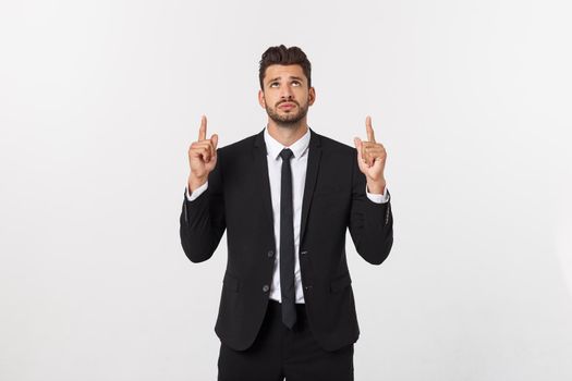 Business Concept: Portrait handsome young businessman point finger on side to empty copy space. Isolated over white background.