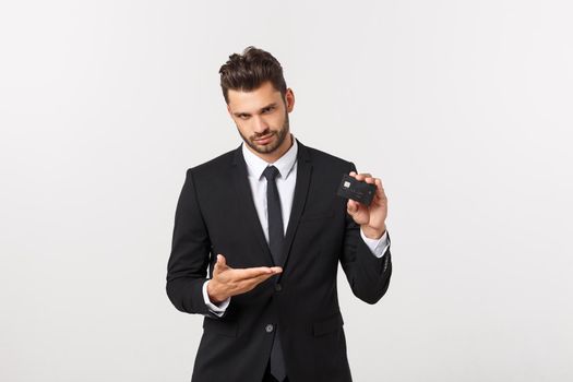 Surprised, speechless and impressed handsome caucasian businessman in classic suit showing credit card, say wow, standing white background astonished.