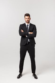 Photo of an attractive businessman with his arms crossed and smiling over a white background