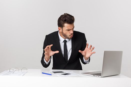 young man shocked with something he see on his laptop computer